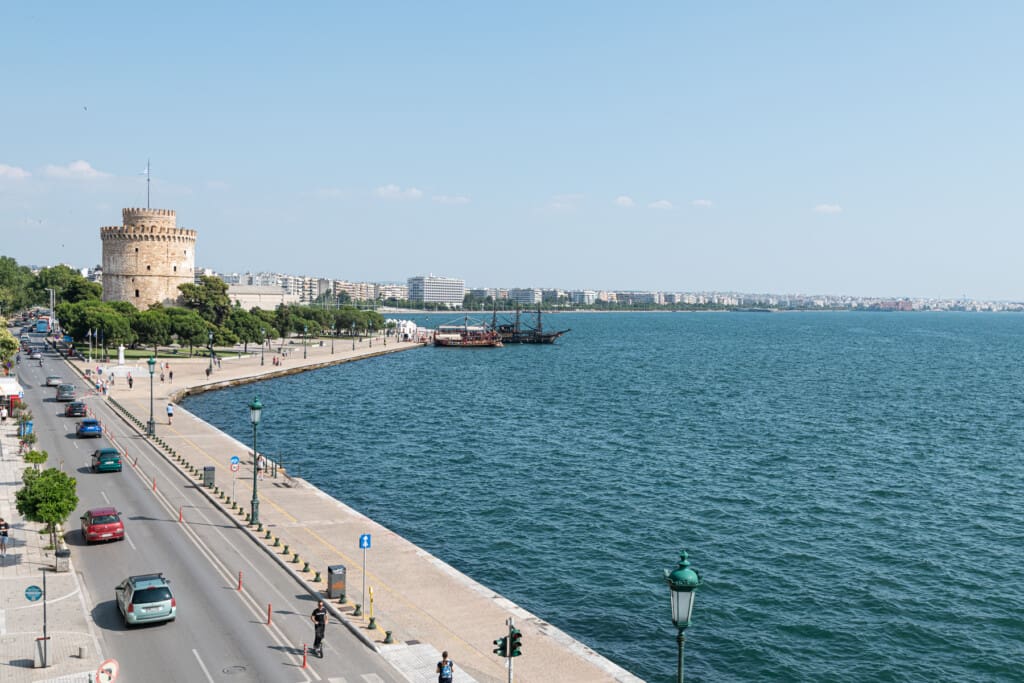 halu! Scenic view of Nikis Avenue in Thessaloniki showcasing the iconic White Tower and stunning sea view perfect for exploring Greece's beautiful waterfront attractions