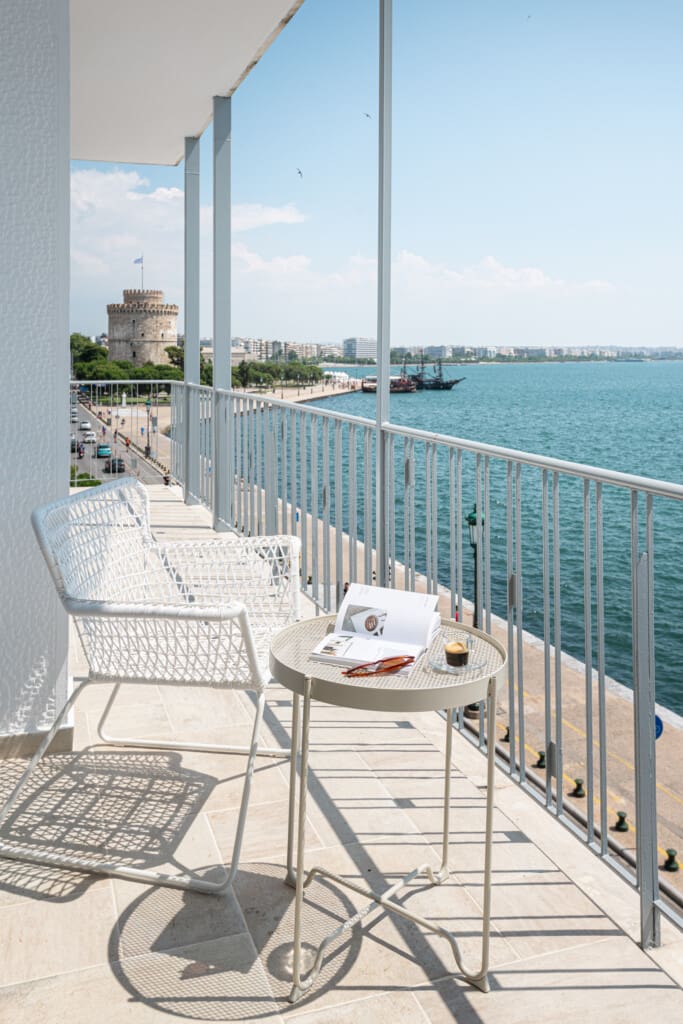 Halu! Enjoy a stunning sea view of Thessaloniki from a balcony on Nikis Avenue with the iconic White Tower visible in the distance on a sunny day.