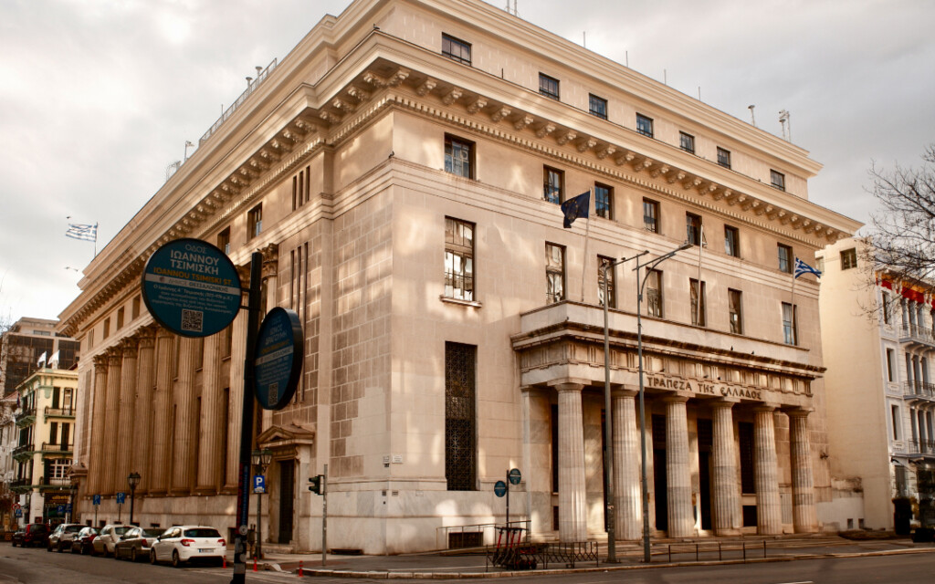Street view of the National Bank of Greece with neoclassical columns at the entrance from Tsimiski Street in Thessaloniki.
