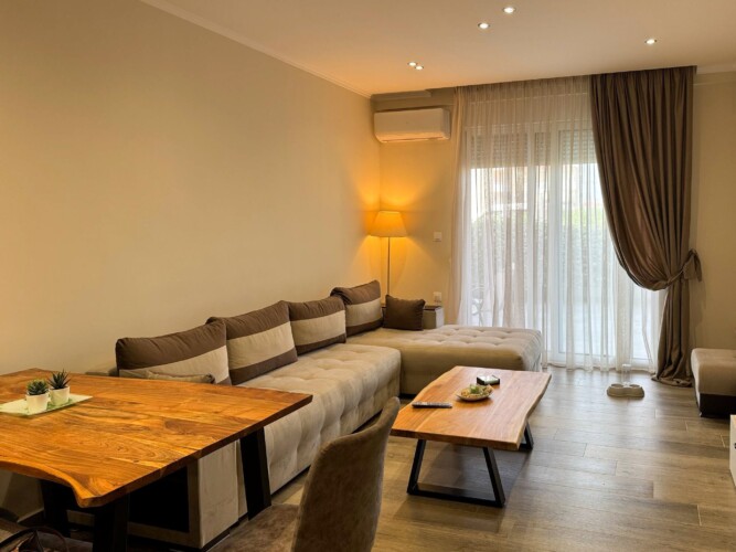 Modern one-bedroom apartment with stylish living room, fully equipped kitchen, terrace, and contemporary design for a comfortable stay in Moudania.