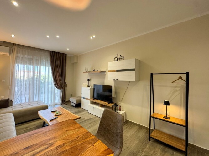 Modern one-bedroom apartment with stylish living room, fully equipped kitchen, terrace, and contemporary design for a comfortable stay in Moudania.