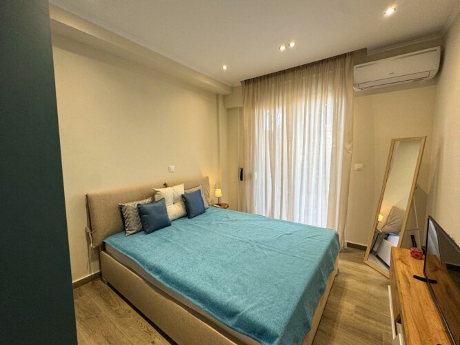 Modern one-bedroom apartment with stylish living room, fully equipped kitchen, terrace, and contemporary design for a comfortable stay in Moudania.