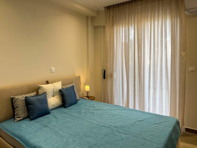 Modern one-bedroom apartment with stylish living room, fully equipped kitchen, terrace, and contemporary design for a comfortable stay in Moudania.