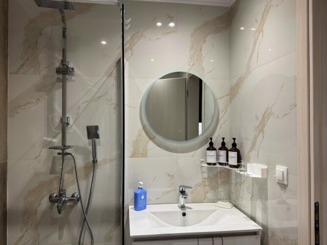 Modern one-bedroom apartment with stylish living room, fully equipped kitchen, terrace, and contemporary design for a comfortable stay in Moudania.