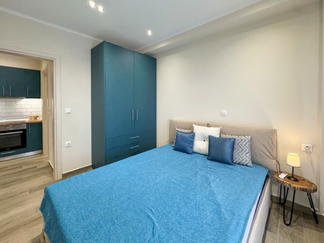 Modern one-bedroom apartment with stylish living room, fully equipped kitchen, terrace, and contemporary design for a comfortable stay in Moudania.