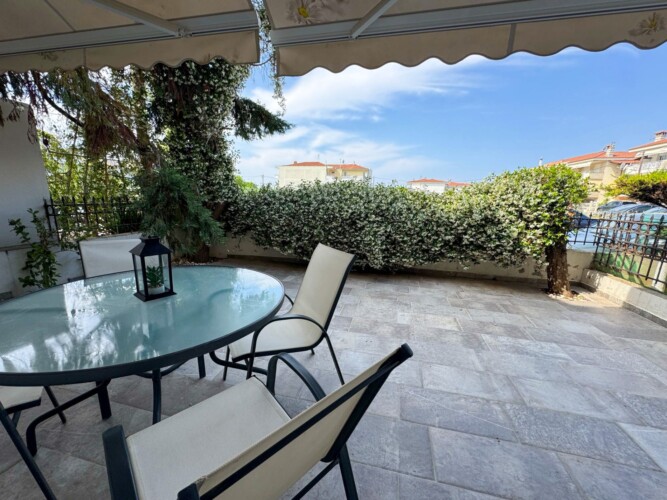 Modern one-bedroom apartment with stylish living room, fully equipped kitchen, terrace, and contemporary design for a comfortable stay in Moudania.