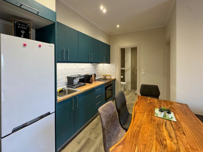 Modern one-bedroom apartment with stylish living room, fully equipped kitchen, terrace, and contemporary design for a comfortable stay in Moudania.