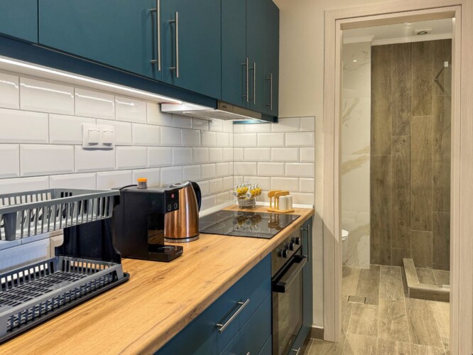 Modern one-bedroom apartment with stylish living room, fully equipped kitchen, terrace, and contemporary design for a comfortable stay in Moudania.