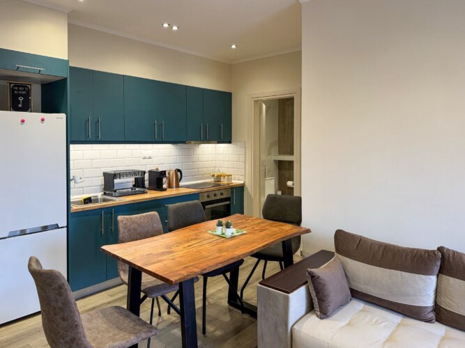 Modern one-bedroom apartment with stylish living room, fully equipped kitchen, terrace, and contemporary design for a comfortable stay in Moudania.