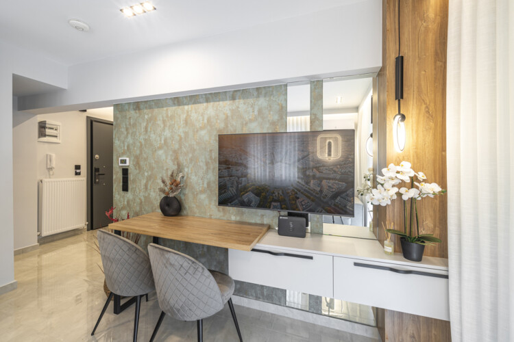 Modern one-bedroom apartment with stylish living room, fully equipped kitchen, private balcony, and contemporary design for a comfortable stay in Thessaloniki.