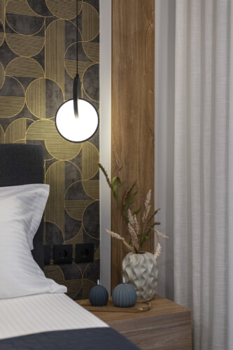 Modern one-bedroom apartment with stylish living room, fully equipped kitchen, private balcony, and contemporary design for a comfortable stay in Thessaloniki.