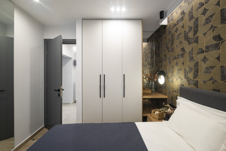 Modern one-bedroom apartment with stylish living room, fully equipped kitchen, private balcony, and contemporary design for a comfortable stay in Thessaloniki.