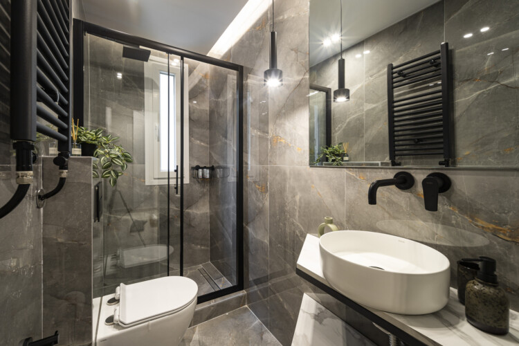 Modern one-bedroom apartment with stylish living room, fully equipped kitchen, private balcony, and contemporary design for a comfortable stay in Thessaloniki.