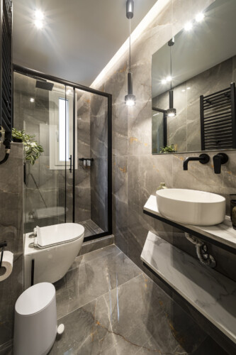 Modern one-bedroom apartment with stylish living room, fully equipped kitchen, private balcony, and contemporary design for a comfortable stay in Thessaloniki.