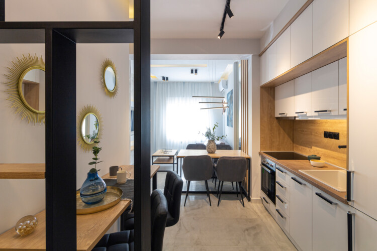 Modern two-bedroom apartment with stylish living room, fully equipped kitchen, balcony, and contemporary design for a comfortable stay in Thessaloniki.