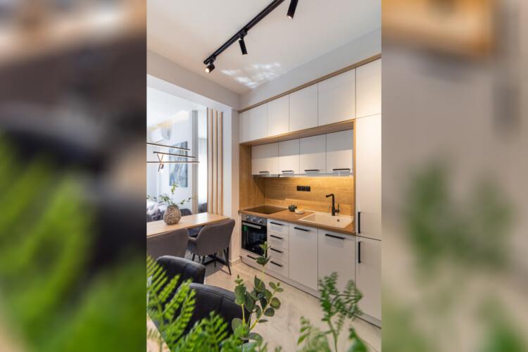 Modern two-bedroom apartment with stylish living room, fully equipped kitchen, balcony, and contemporary design for a comfortable stay in Thessaloniki.