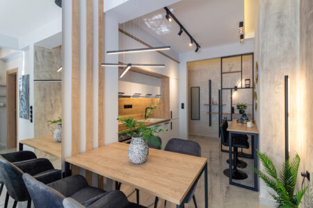 Modern two-bedroom apartment with stylish living room, fully equipped kitchen, balcony, and contemporary design for a comfortable stay in Thessaloniki.