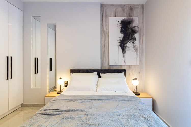 Modern two-bedroom apartment with stylish living room, fully equipped kitchen, balcony, and contemporary design for a comfortable stay in Thessaloniki.