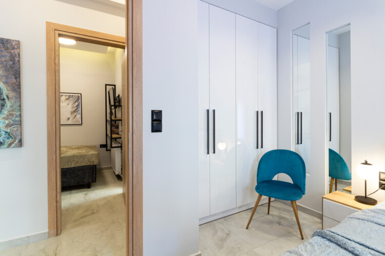 Modern two-bedroom apartment with stylish living room, fully equipped kitchen, balcony, and contemporary design for a comfortable stay in Thessaloniki.