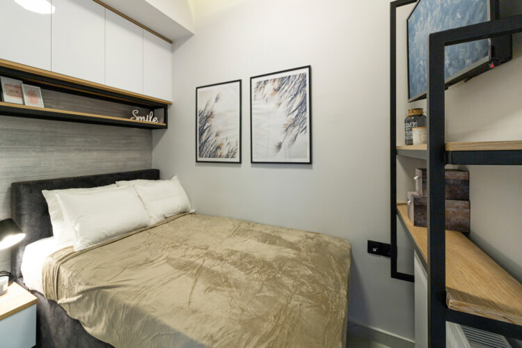 Modern two-bedroom apartment with stylish living room, fully equipped kitchen, balcony, and contemporary design for a comfortable stay in Thessaloniki.