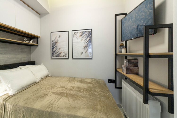 Modern two-bedroom apartment with stylish living room, fully equipped kitchen, balcony, and contemporary design for a comfortable stay in Thessaloniki.