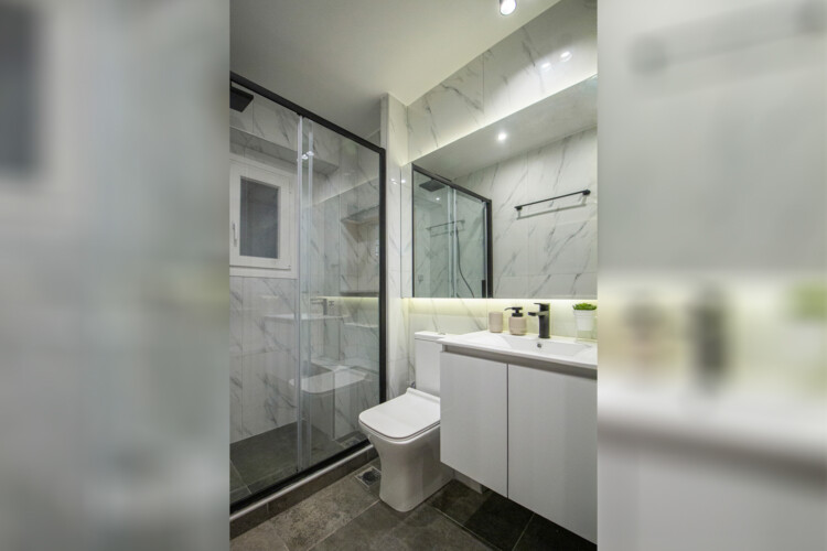 Modern two-bedroom apartment with stylish living room, fully equipped kitchen, balcony, and contemporary design for a comfortable stay in Thessaloniki.