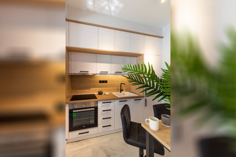 Modern two-bedroom apartment with stylish living room, fully equipped kitchen, balcony, and contemporary design for a comfortable stay in Thessaloniki.