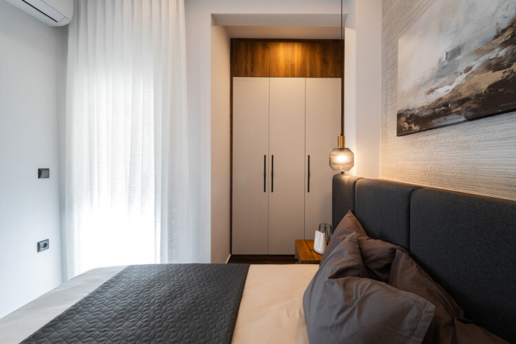 Modern two-bedroom apartment with stylish living room, fully equipped kitchen, balcony, and contemporary design for a comfortable stay in Thessaloniki.