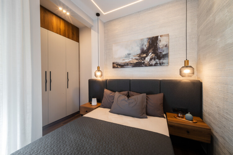 Modern two-bedroom apartment with stylish living room, fully equipped kitchen, balcony, and contemporary design for a comfortable stay in Thessaloniki.