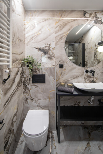 Modern two-bedroom apartment with stylish living room, fully equipped kitchen, balcony, and contemporary design for a comfortable stay in Thessaloniki.