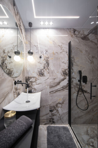 Modern two-bedroom apartment with stylish living room, fully equipped kitchen, balcony, and contemporary design for a comfortable stay in Thessaloniki.