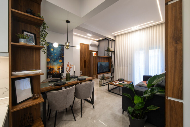 Modern two-bedroom apartment with stylish living room, fully equipped kitchen, balcony, and contemporary design for a comfortable stay in Thessaloniki.