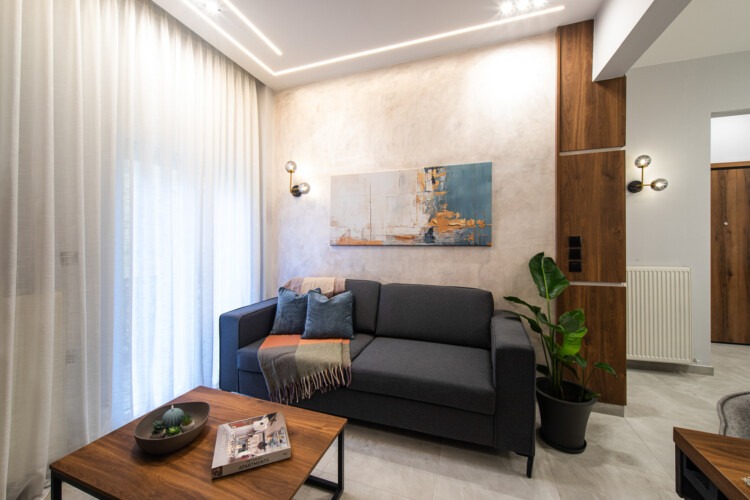 Modern two-bedroom apartment with stylish living room, fully equipped kitchen, balcony, and contemporary design for a comfortable stay in Thessaloniki.