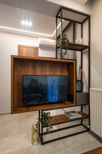 Modern two-bedroom apartment with stylish living room, fully equipped kitchen, balcony, and contemporary design for a comfortable stay in Thessaloniki.