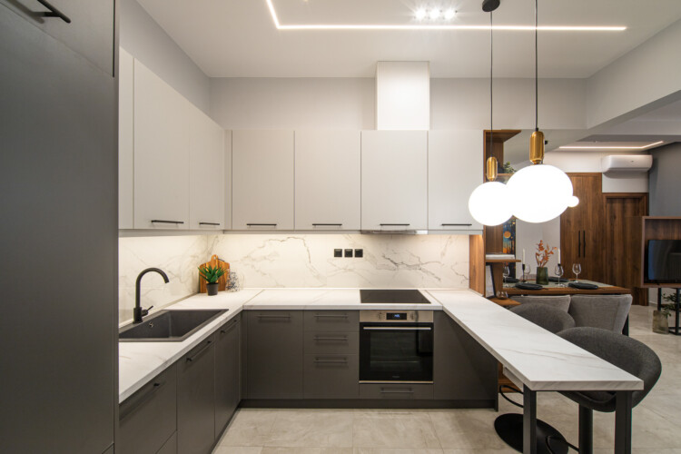 Modern two-bedroom apartment with stylish living room, fully equipped kitchen, balcony, and contemporary design for a comfortable stay in Thessaloniki.