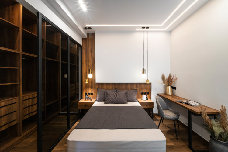 Modern two-bedroom apartment with stylish living room, fully equipped kitchen, balcony, and contemporary design for a comfortable stay in Thessaloniki.