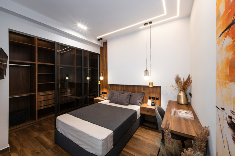 Modern two-bedroom apartment with stylish living room, fully equipped kitchen, balcony, and contemporary design for a comfortable stay in Thessaloniki.