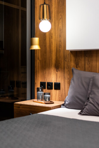 Modern two-bedroom apartment with stylish living room, fully equipped kitchen, balcony, and contemporary design for a comfortable stay in Thessaloniki.