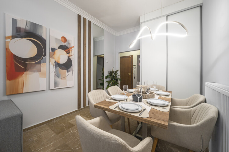 Modern three-bedroom apartment with stylish living room, fully equipped kitchen, balcony, and contemporary design for a comfortable stay in Thessaloniki.