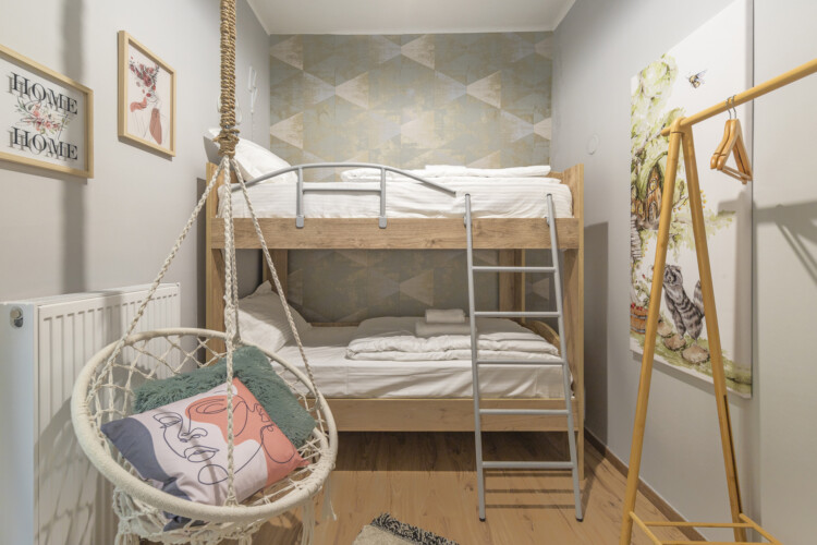 Modern three-bedroom apartment with stylish living room, fully equipped kitchen, balcony, and contemporary design for a comfortable stay in Thessaloniki.