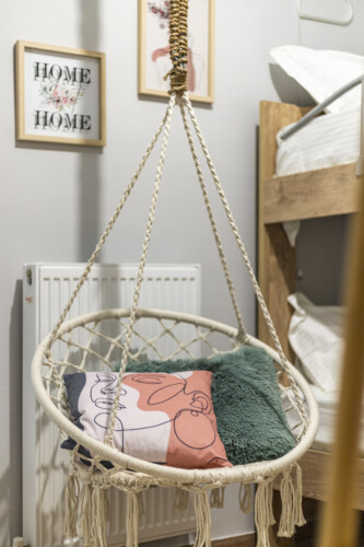 Modern three-bedroom apartment with stylish living room, fully equipped kitchen, balcony, and contemporary design for a comfortable stay in Thessaloniki.