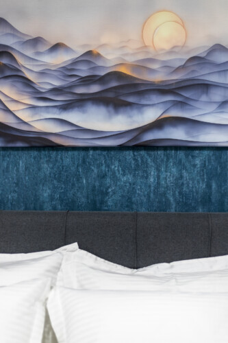 Modern three-bedroom apartment with stylish living room, fully equipped kitchen, balcony, and contemporary design for a comfortable stay in Thessaloniki.