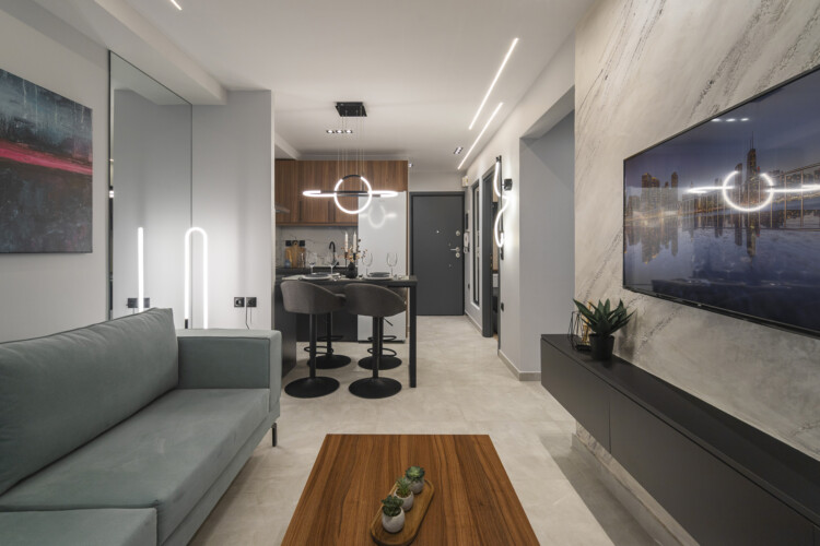 Modern two-bedroom apartment with stylish living room, fully equipped kitchen, balcony, and contemporary design for a comfortable stay in Thessaloniki.