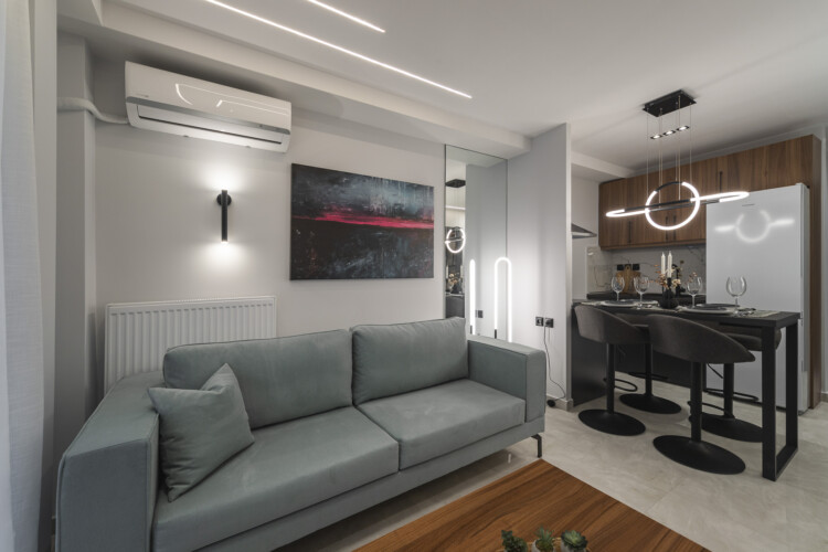 Modern two-bedroom apartment with stylish living room, fully equipped kitchen, balcony, and contemporary design for a comfortable stay in Thessaloniki.