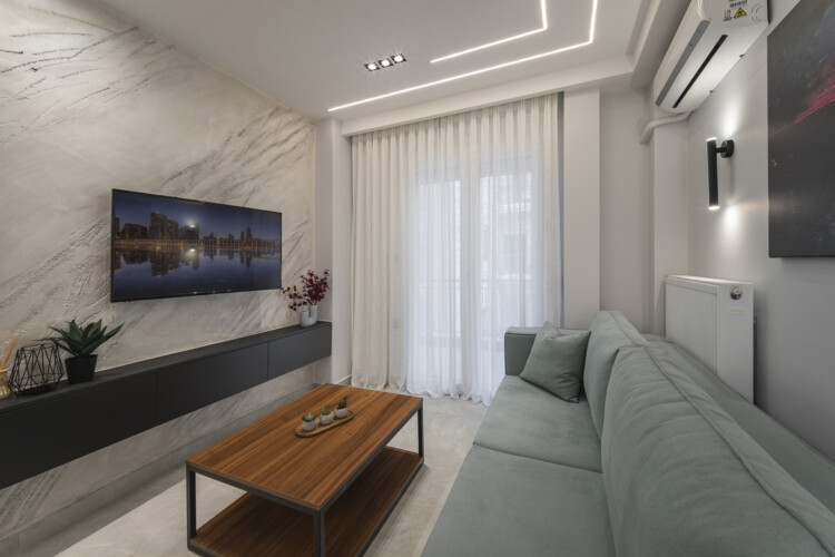 Modern two-bedroom apartment with stylish living room, fully equipped kitchen, balcony, and contemporary design for a comfortable stay in Thessaloniki.
