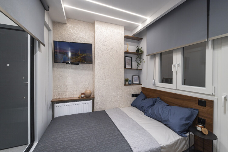 Modern two-bedroom apartment with stylish living room, fully equipped kitchen, balcony, and contemporary design for a comfortable stay in Thessaloniki.