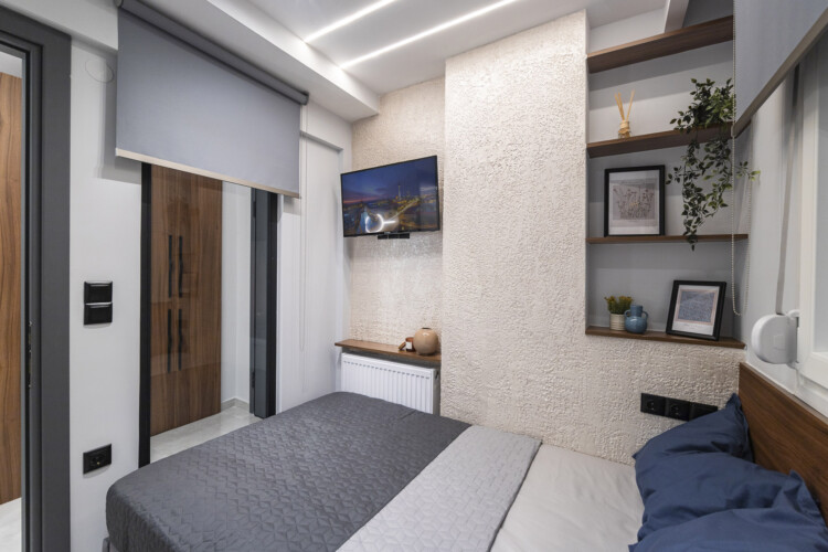 Modern two-bedroom apartment with stylish living room, fully equipped kitchen, balcony, and contemporary design for a comfortable stay in Thessaloniki.