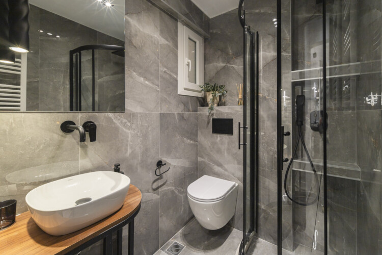 Modern two-bedroom apartment with stylish living room, fully equipped kitchen, balcony, and contemporary design for a comfortable stay in Thessaloniki.