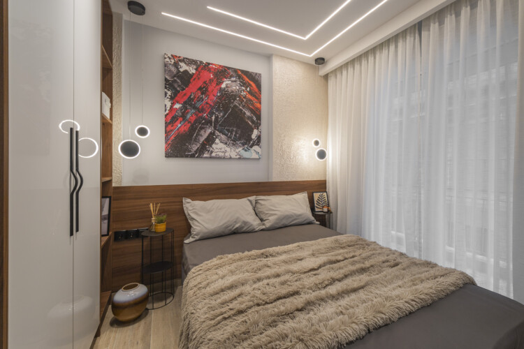 Modern two-bedroom apartment with stylish living room, fully equipped kitchen, balcony, and contemporary design for a comfortable stay in Thessaloniki.
