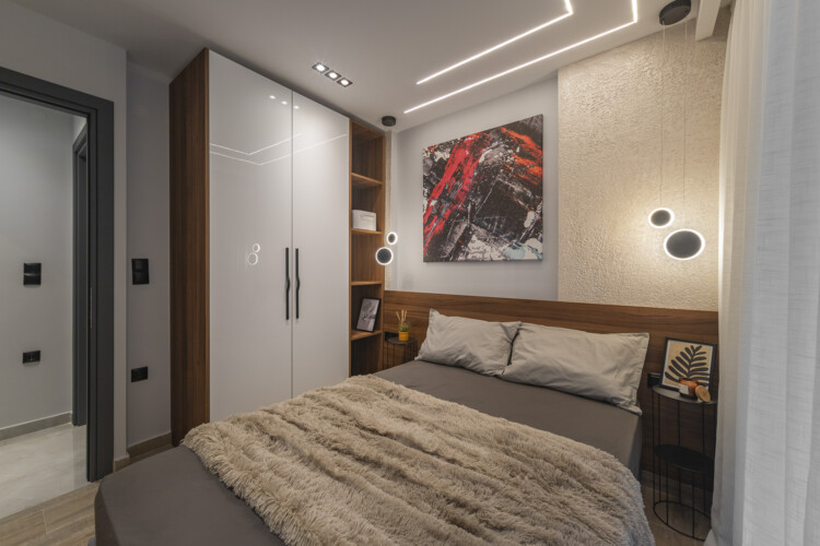 Modern two-bedroom apartment with stylish living room, fully equipped kitchen, balcony, and contemporary design for a comfortable stay in Thessaloniki.